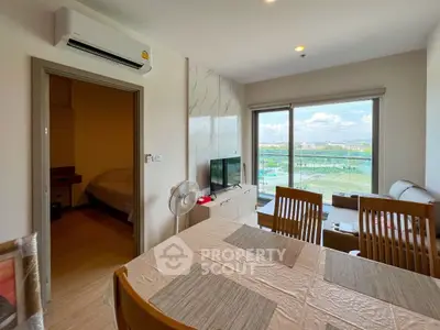Modern living room with dining area and balcony view in a stylish apartment.