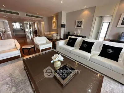 Luxurious living room with elegant white sofas and modern decor in a spacious open layout.