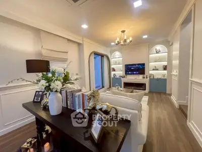 Elegant living room with modern decor, built-in shelves, and cozy lighting