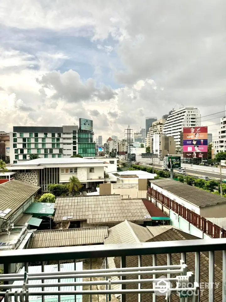 Stunning cityscape view from a high-rise balcony showcasing urban skyline and vibrant architecture.