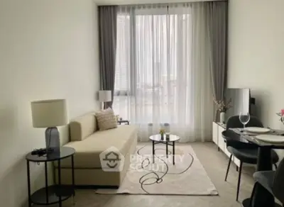 Elegant living room with modern furnishings, ample natural light, and a neutral color palette, perfect for relaxation or entertaining guests.