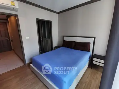 Cozy bedroom with modern decor and wooden flooring in a stylish apartment.