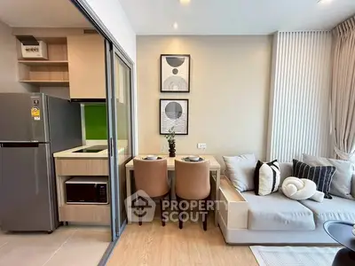 Modern open-plan living room with stylish kitchen and cozy seating area, perfect for urban living.