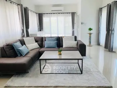 Spacious modern living room with elegant sectional sofa and natural light
