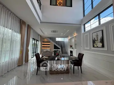 Luxurious modern living room with high ceilings and elegant decor