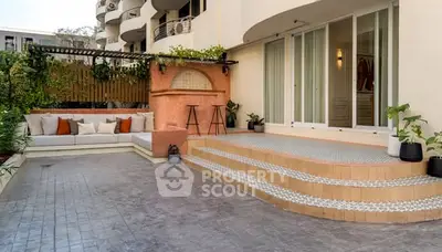 Charming outdoor patio with stylish seating and elegant tiled steps, perfect for relaxation and entertaining.