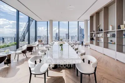 Luxurious penthouse with panoramic city views and elegant marble dining table.