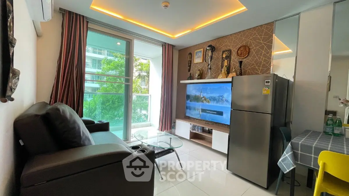 Modern living room with balcony, stylish decor, and sleek appliances.