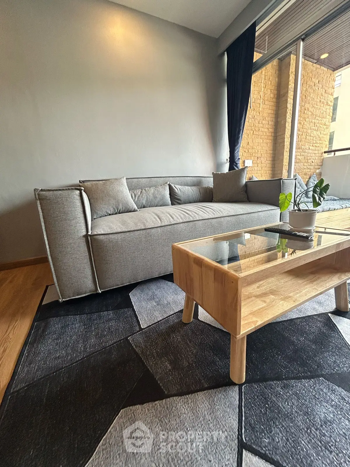 Modern living room with stylish gray sofa and wooden coffee table