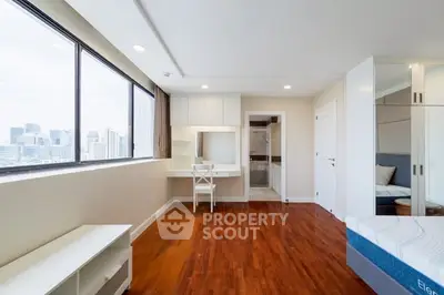 Spacious bedroom with city view and elegant wooden flooring