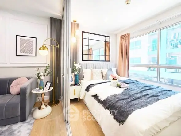 Bright and cozy bedroom with modern decor and large window view.