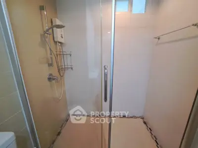 Modern bathroom with glass shower enclosure and sleek fixtures