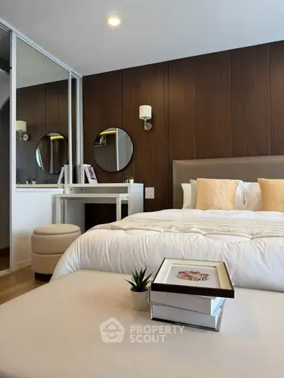 Luxurious bedroom with elegant decor and cozy ambiance, featuring a stylish vanity and plush bedding.