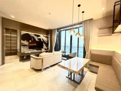 Luxurious living room with stunning ocean view, modern furniture, and elegant lighting in a high-end apartment.