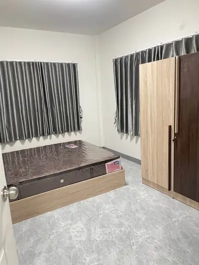 Cozy bedroom with modern furnishings and ample natural light