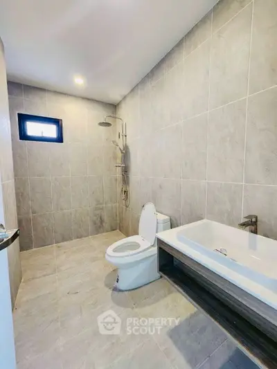 Modern bathroom with sleek tile design and spacious layout