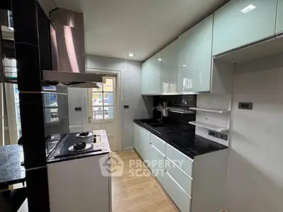 Modern kitchen with sleek cabinetry and gas stove in a stylish apartment