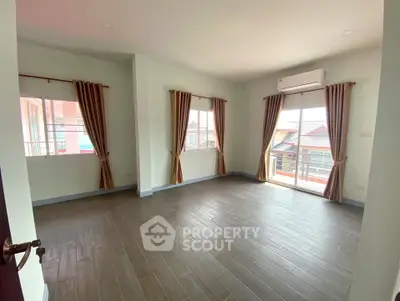 Spacious empty room with large windows and balcony access, perfect for customization.