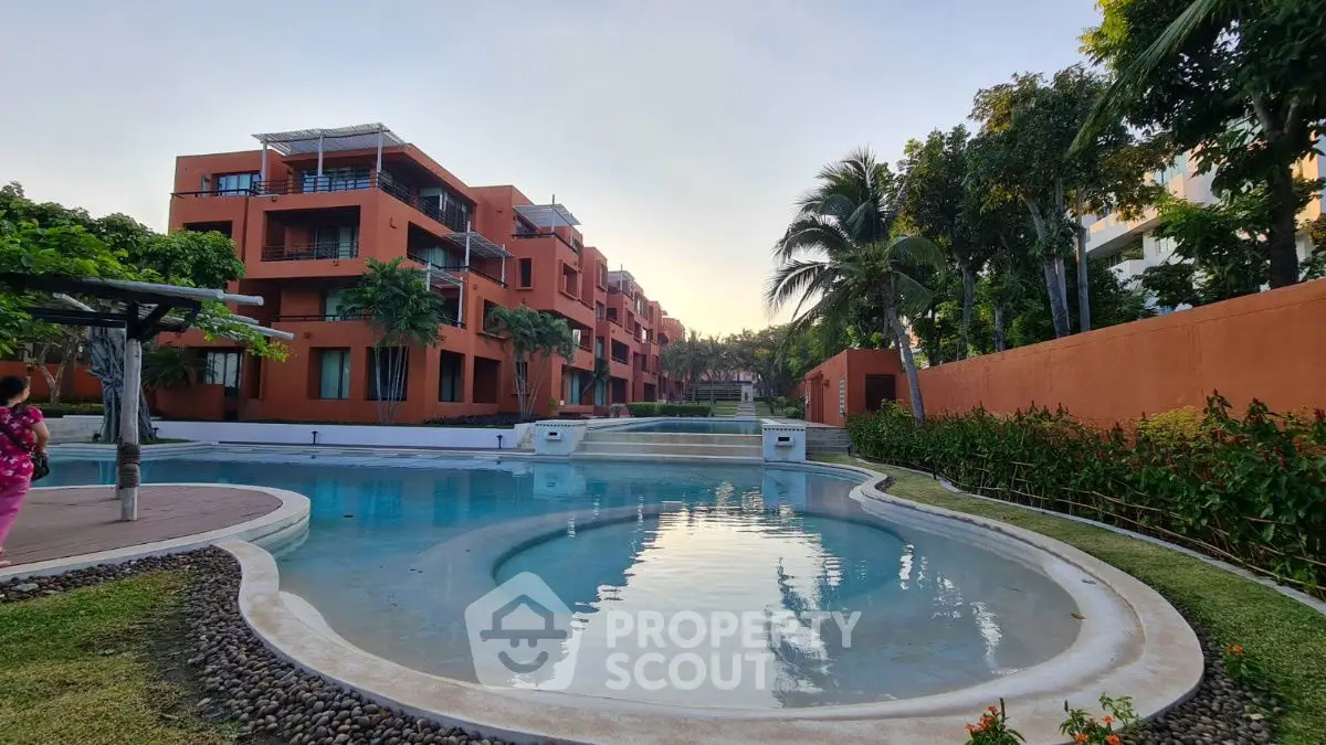 Luxurious residential complex with stunning pool and lush greenery, perfect for a serene lifestyle.