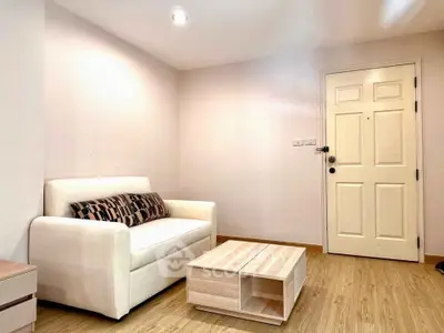Cozy living room with modern sofa and wooden coffee table, perfect for relaxation.