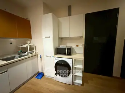 Compact kitchen with modern appliances and sleek cabinetry