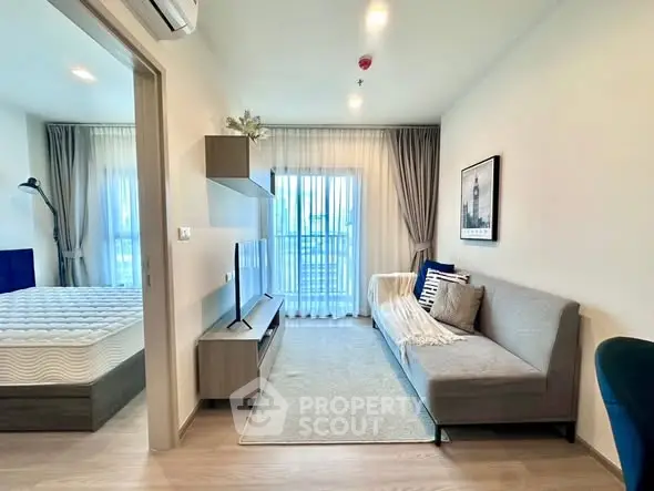 Modern living room with cozy sofa and natural light near bedroom