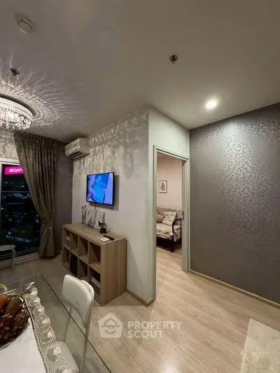 Modern living room with elegant lighting and open doorway to cozy bedroom.