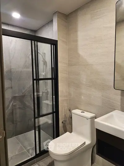 Modern bathroom with sleek shower enclosure and elegant fixtures
