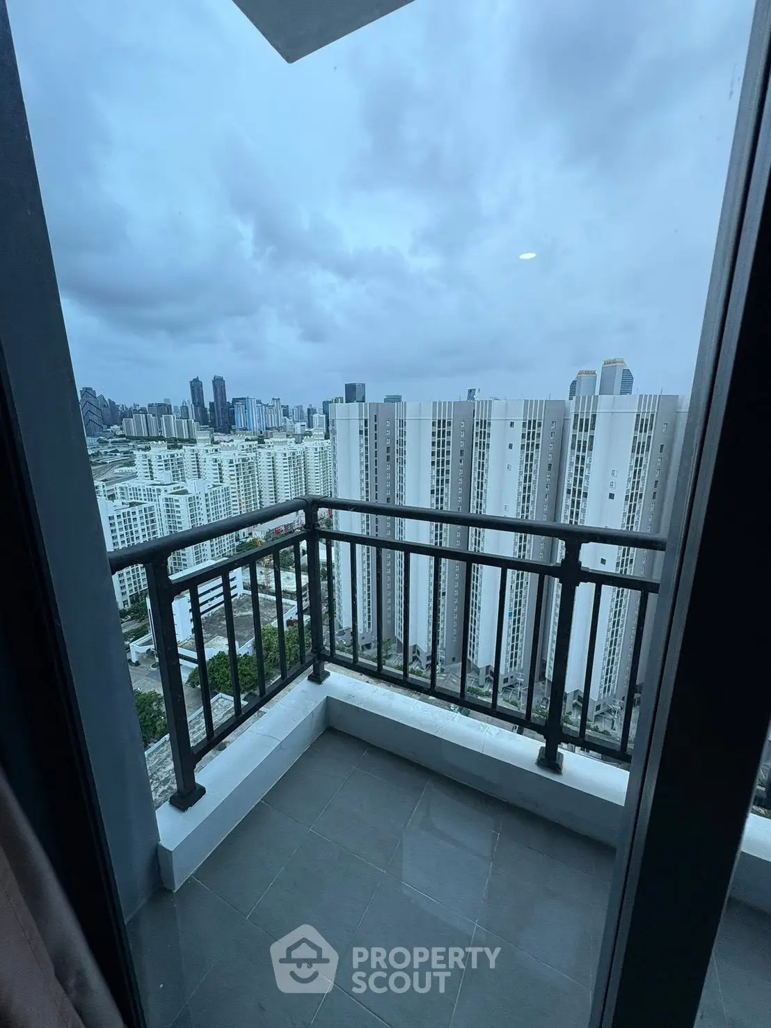 Stunning high-rise balcony view overlooking city skyline with modern architecture.