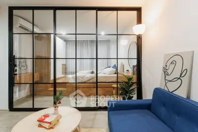 Modern living room with glass partition and cozy bedroom view