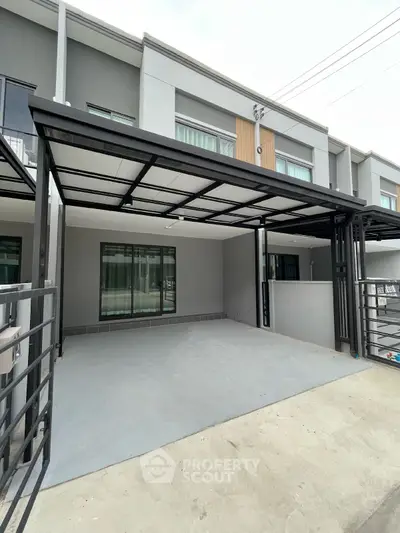 Modern townhouse exterior with covered parking and sleek design
