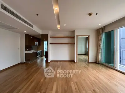 Spacious modern living room with wooden flooring and open kitchen layout