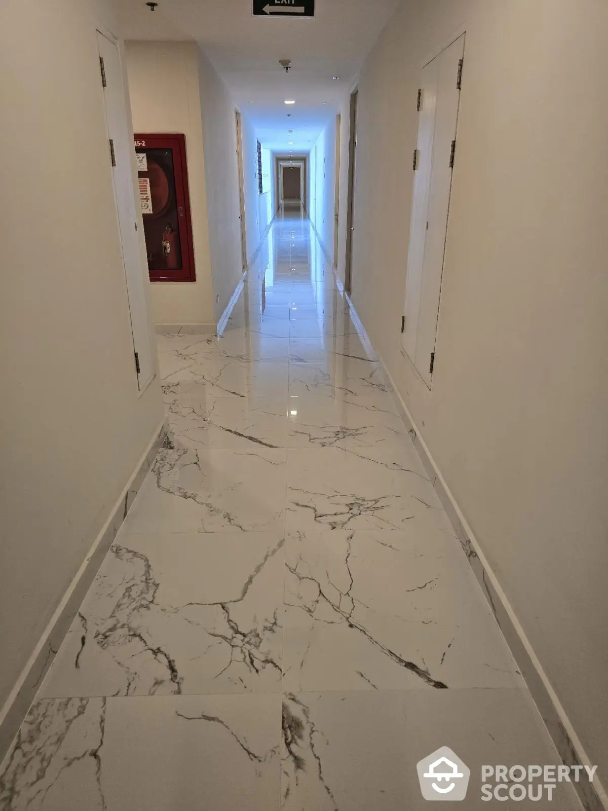 Elegant marble hallway with modern lighting in upscale residential building