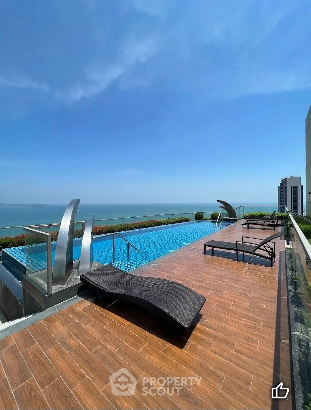 Luxurious rooftop pool with stunning ocean view and modern lounge chairs.