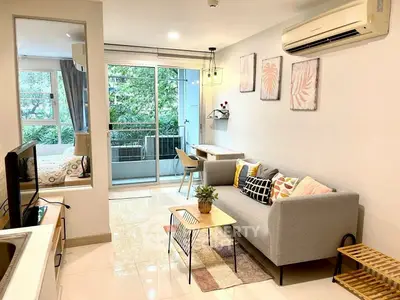 Modern living room with balcony view, stylish decor, and open layout in a cozy apartment.