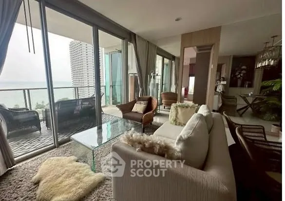 Luxurious living room with stunning ocean view and spacious balcony.