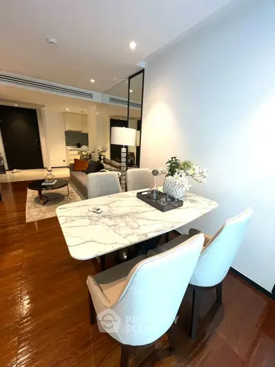Elegant dining area with marble table and plush chairs in modern apartment