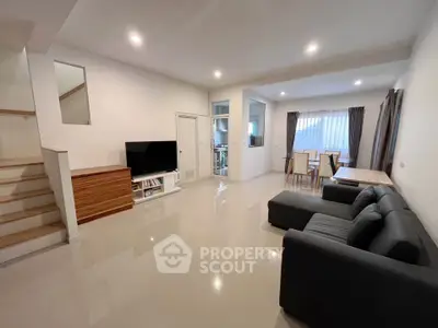 Spacious modern living room with sleek furniture and open layout, perfect for family gatherings.