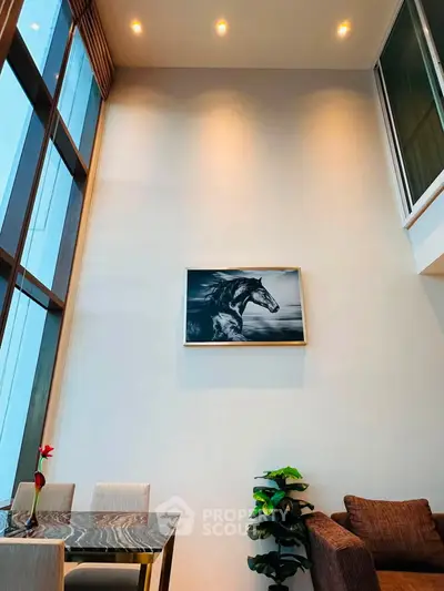 Stunning high-ceiling living room with modern decor and large windows