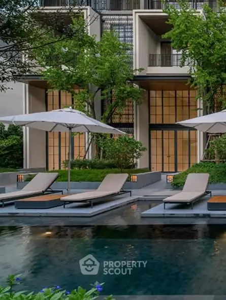 Luxurious apartment building with serene poolside and lush greenery, perfect for relaxation and leisure.