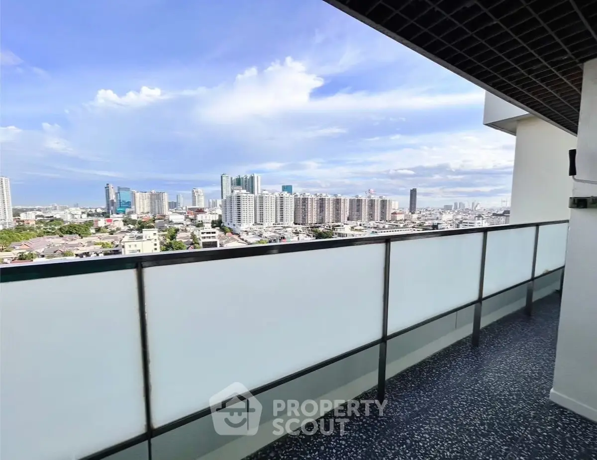 Stunning cityscape view from a spacious balcony in a modern high-rise apartment.