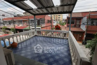 Spacious balcony with tiled floor and city view, perfect for relaxation and outdoor activities.