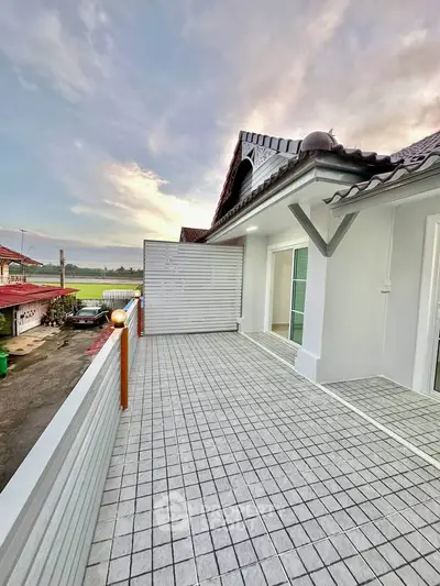 Spacious balcony with scenic view and modern design tiles, perfect for relaxation.