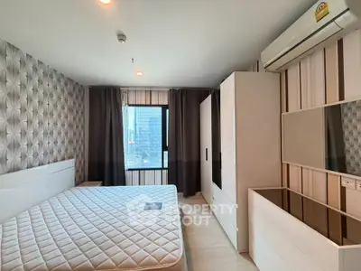 Modern bedroom with stylish wallpaper and city view, featuring a sleek wardrobe and air conditioning.
