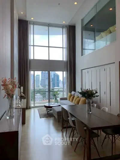 Spacious modern living room with high ceilings and city view