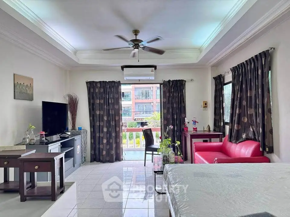 Spacious living room with modern decor and balcony view in a stylish apartment.