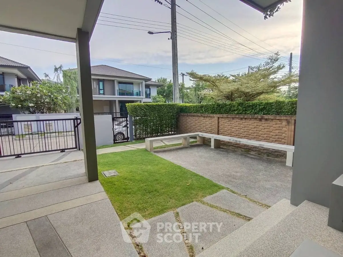 Modern residential garden with stone pathway and seating area