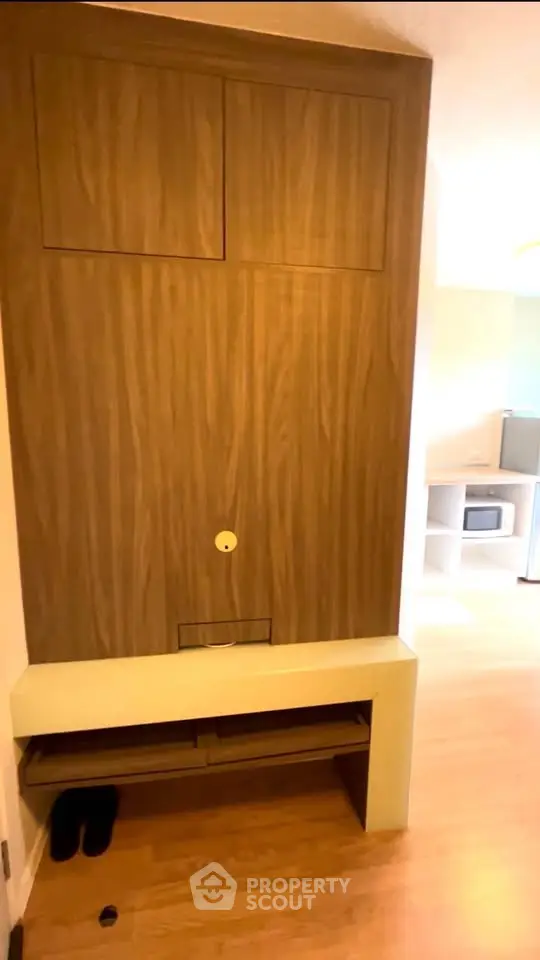 Modern interior with wooden paneling and built-in storage in a cozy apartment.
