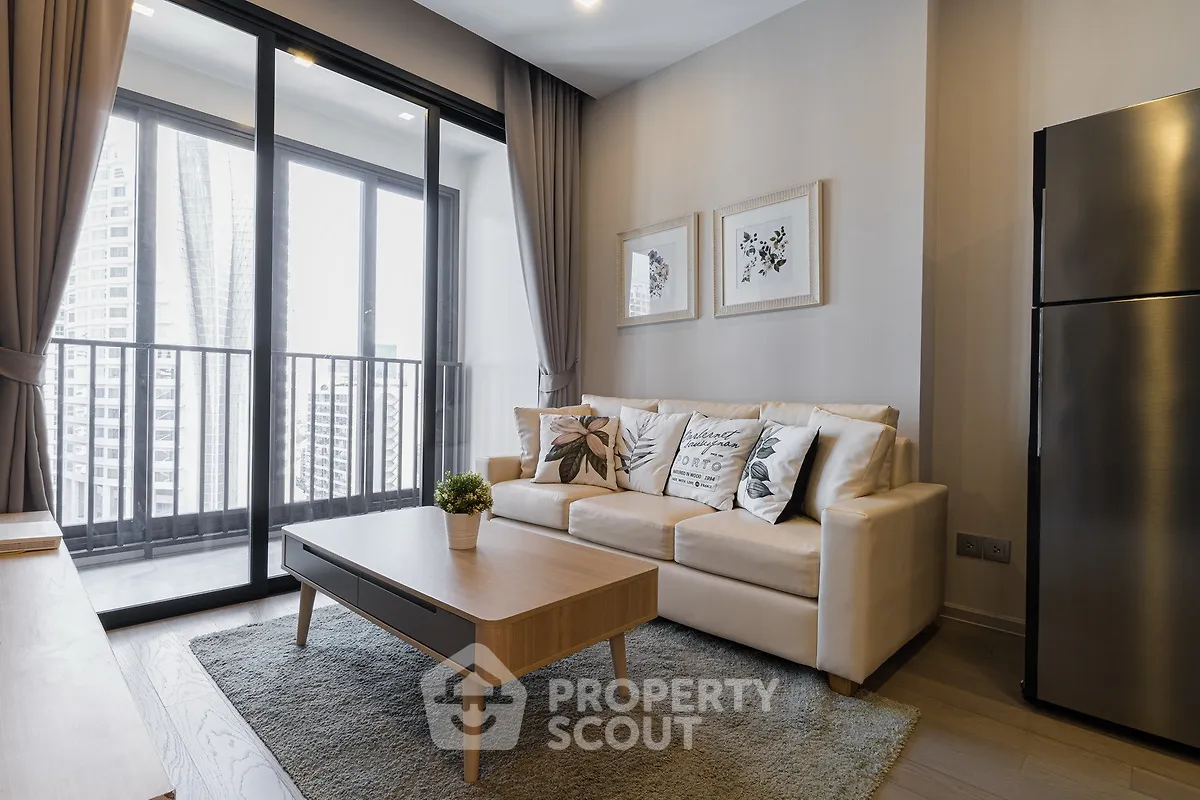 Modern living room with balcony view and stylish decor in a high-rise apartment.