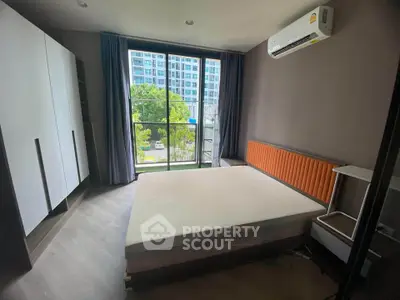 Modern bedroom with large window and air conditioning in urban apartment